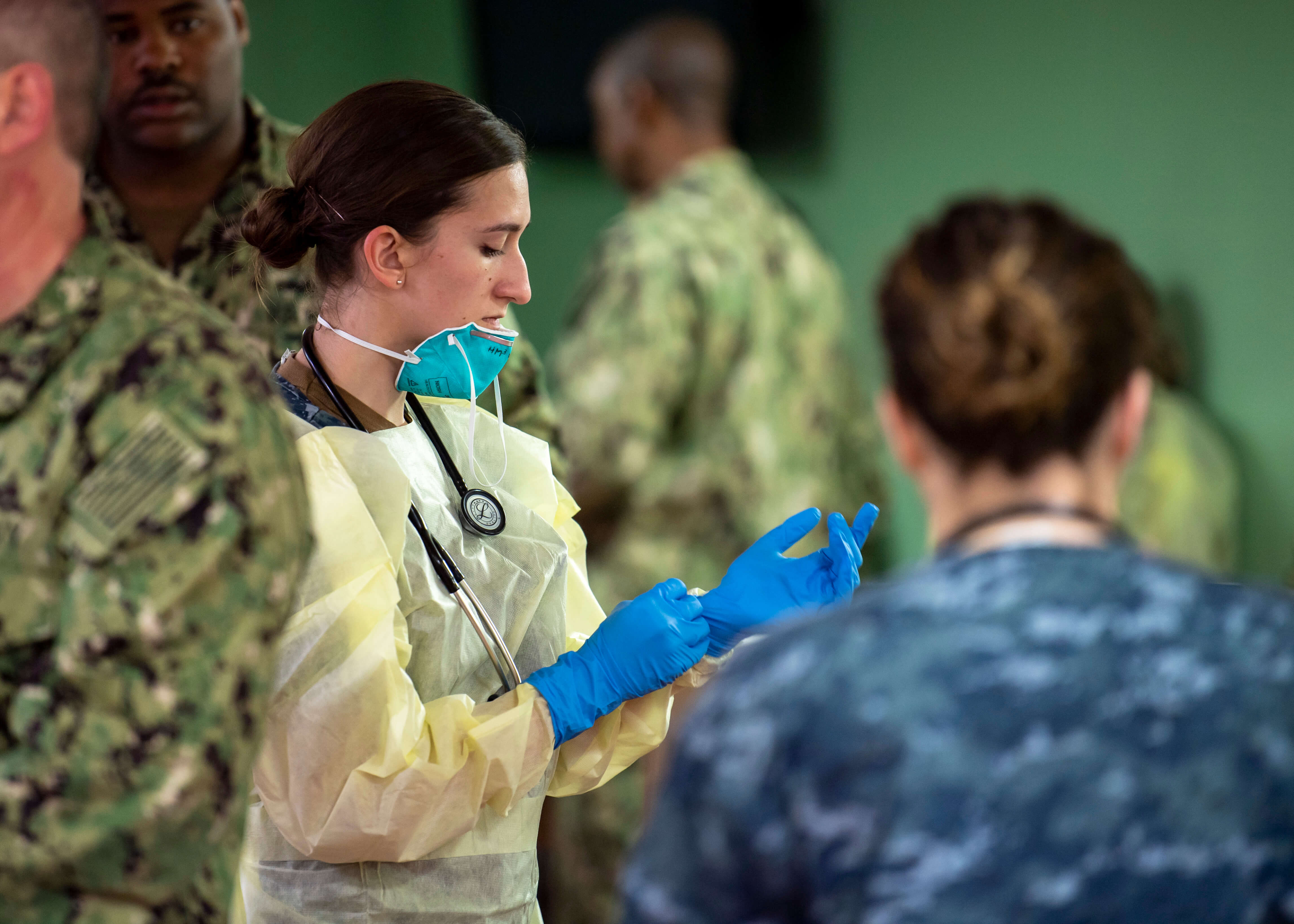 Hospital Corpsman dons surgical gloves aboard the hospital ship USNS Mercy. © U.S. Pacific Fleet / Flickr