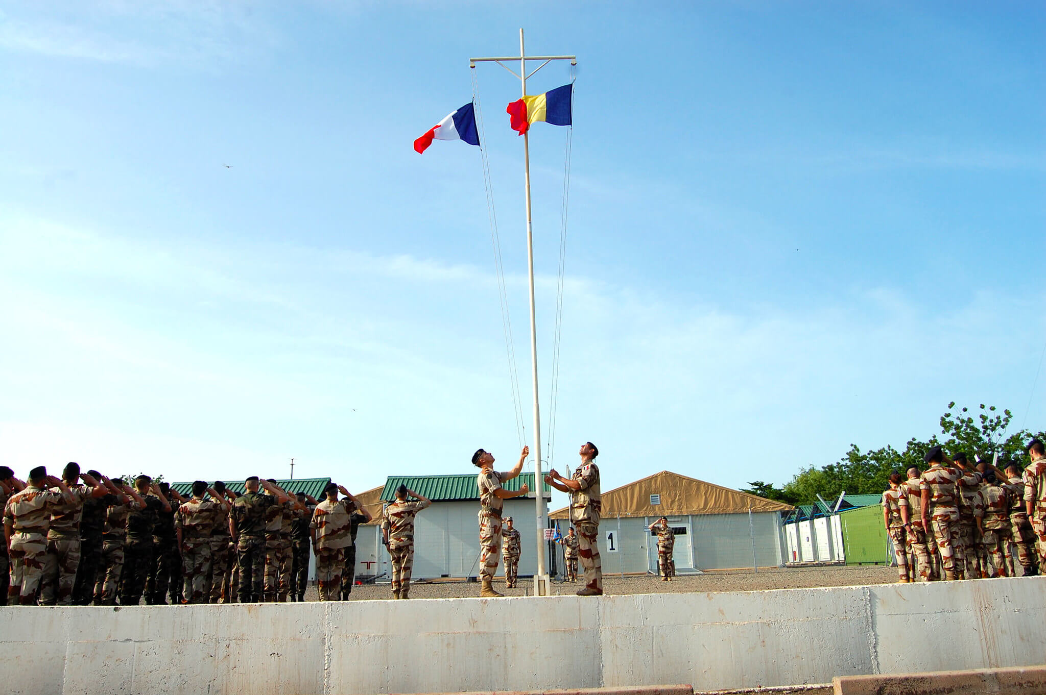 French and Chad military participate in a flag ceremony to commemorate the launch of Operation Barkhane, an anti-terrorist operation in Africa's Sahel region beginning in July 2014. © US Army Africa