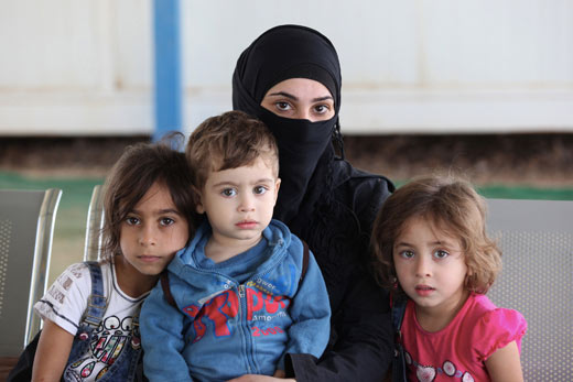 Een Syrische vluchteling met haar kinderen
