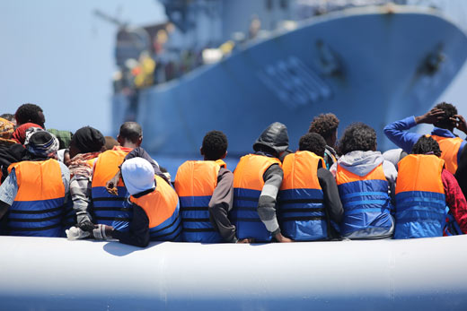 Migrants in front of the Belgian vessel Godetia for Operation Triton in 2015.