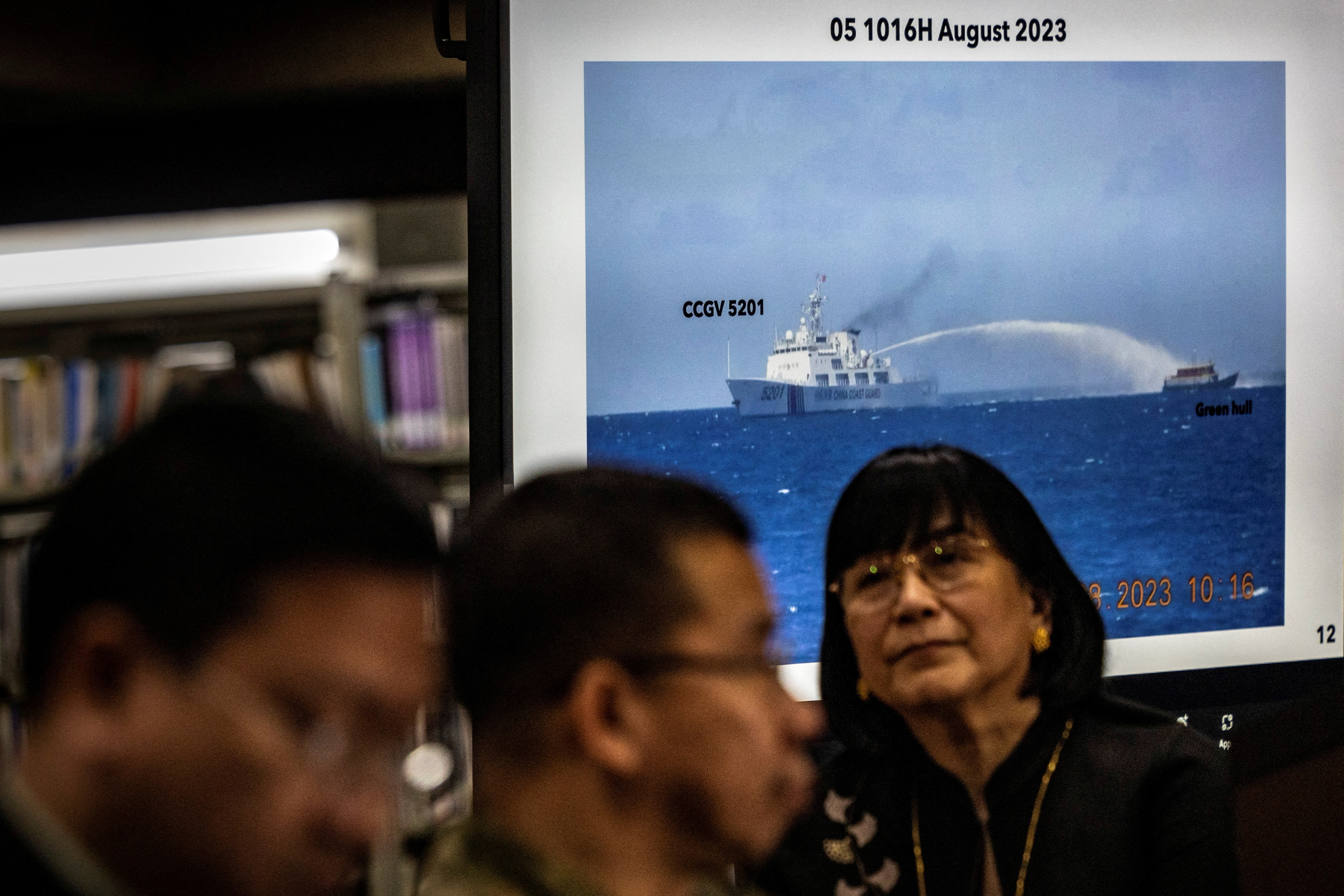 Footage of a Chinese Coast Guard ship using a water cannon against a Filipino resupply vessel is shown during a press conference at the Department of Foreign Affairs in Manila, Philippines, 7 August 2023. © Ezra Acayan/Pool via Reuters