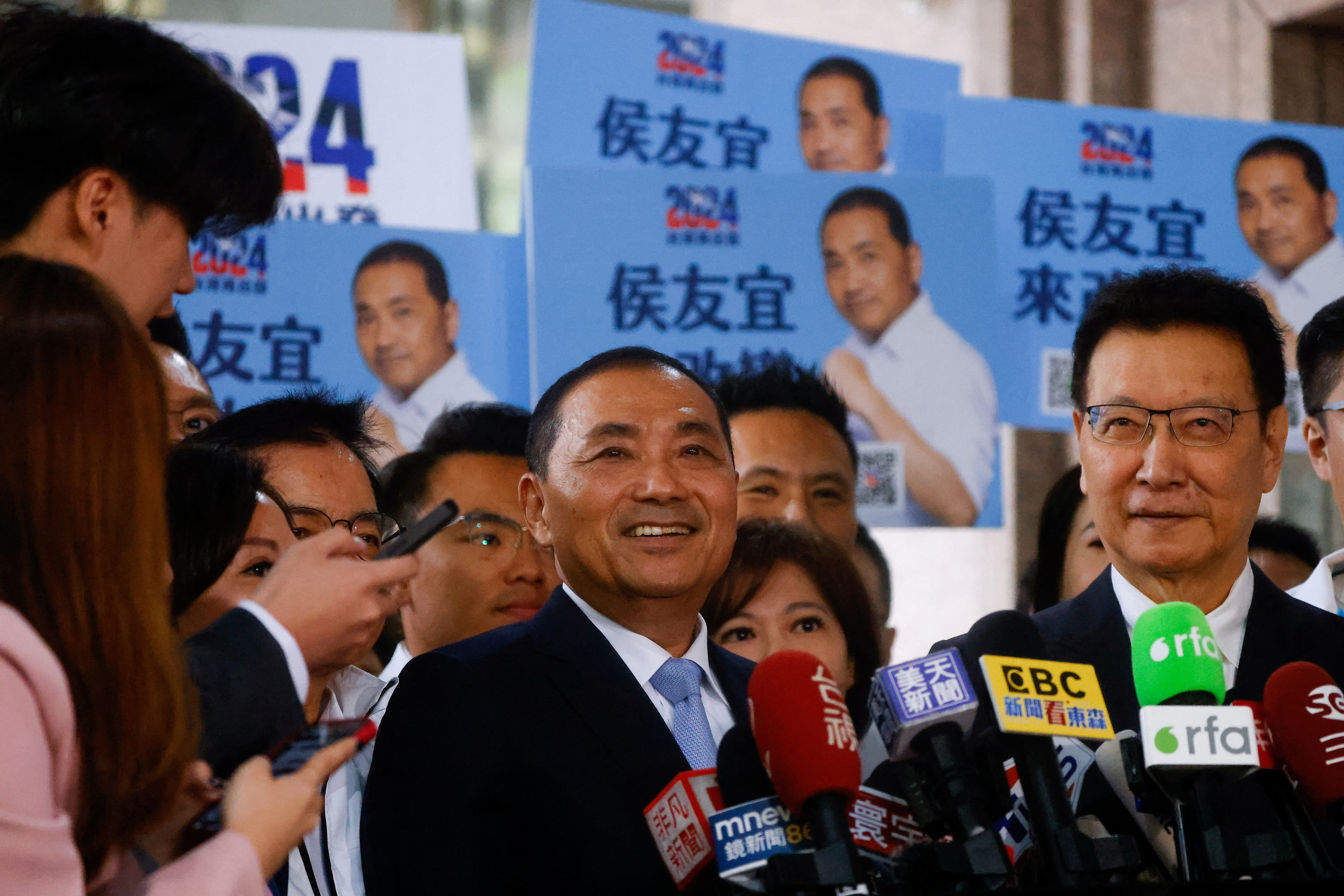 Hou Yu-ih, candidate for Taiwan's presidency from the main opposition party Kuomintang (KMT) and Jaw Shaw-Kong, candidate for vice president, speak to the media after registering at the Central Election Commission in Taipei, Taiwan, 24November 2023. © Ann Wang via Reuters.