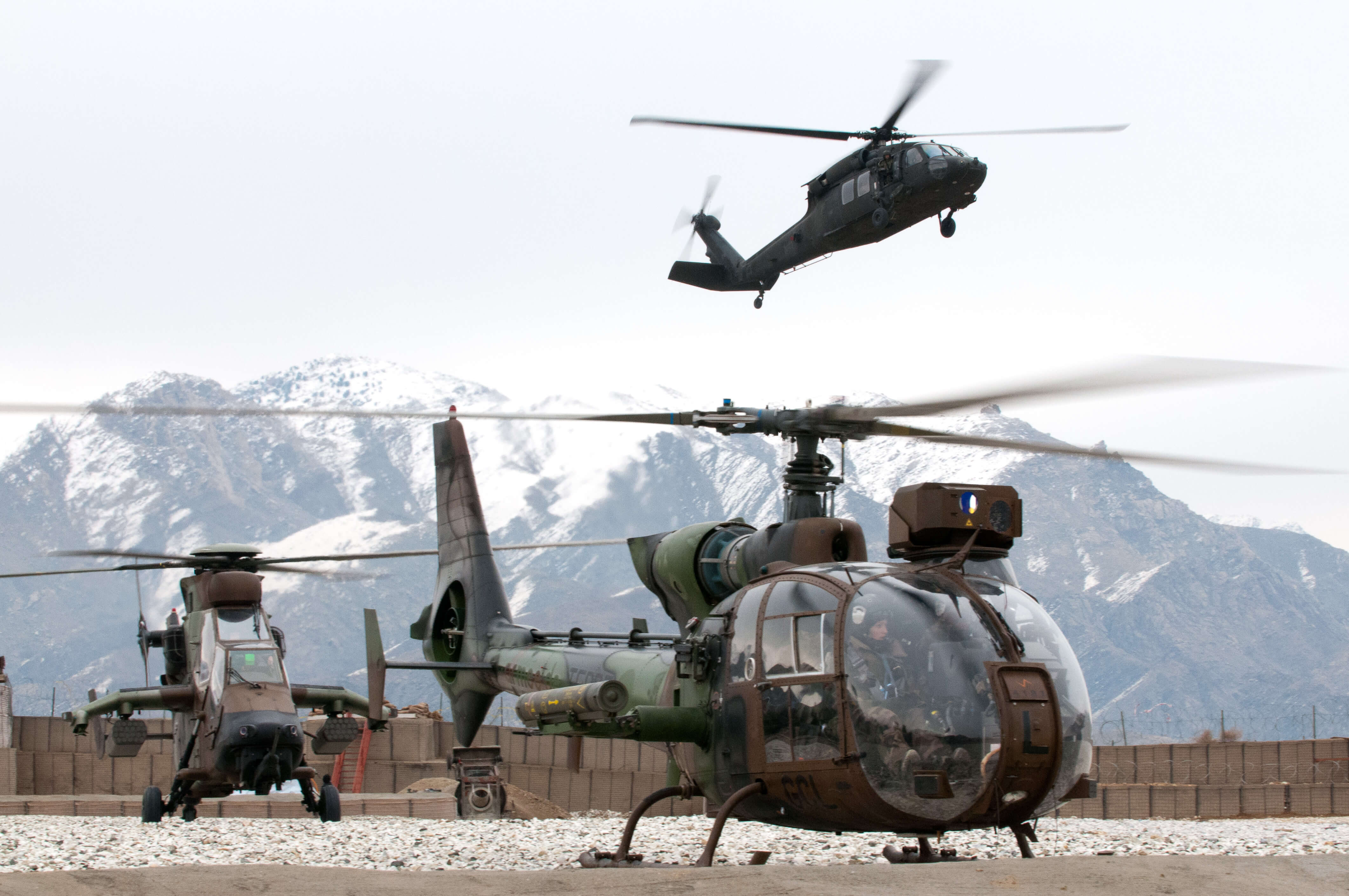 Bouemar-French helicopters, Gazelle (front) and Tigre (rear), wait for a UH-60 Blackhawk helicopter to land at FOB Nejrab, Kapisa province, Afghanistan in 2012. ResoluteSupportMedia