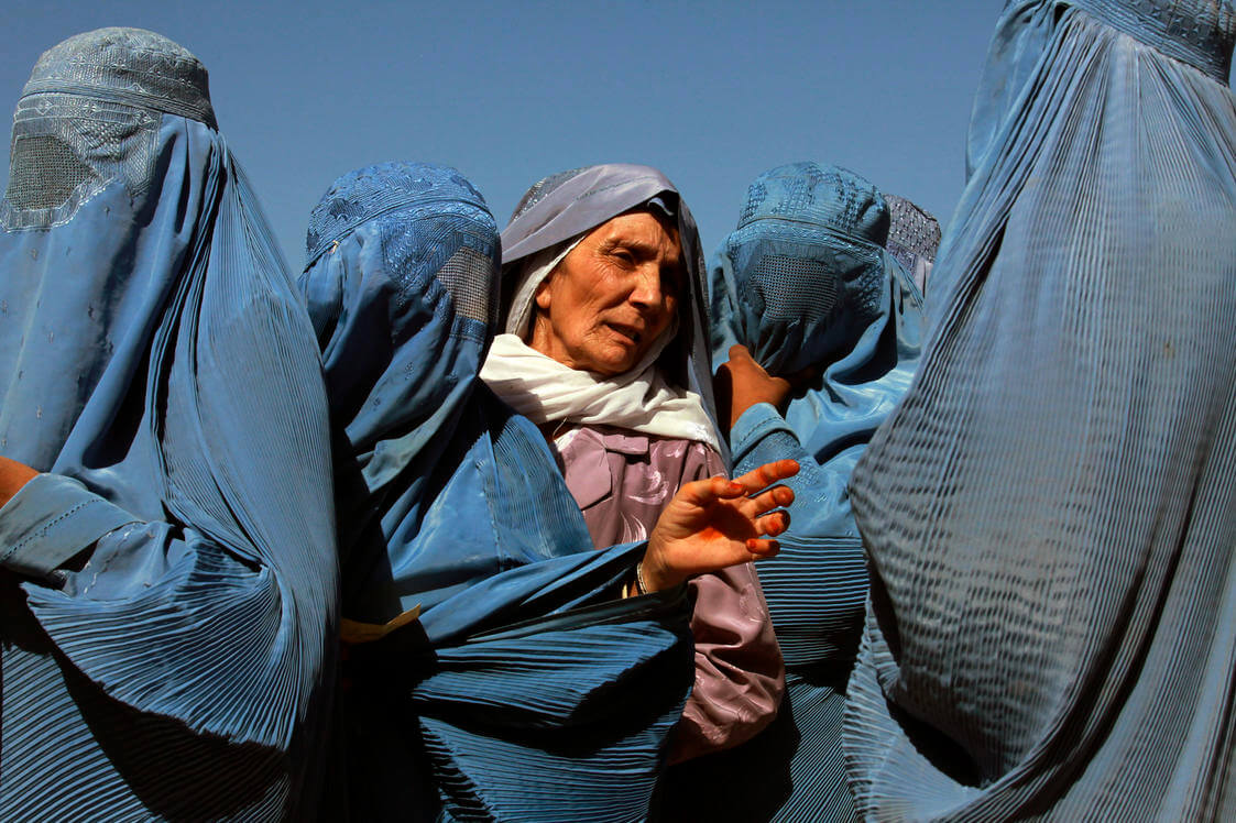Criekemans - In 2012 in Herat, Afghanistan, women line up to collect bags of split chick pea, wheat, and cooking oil being distributed by the UN World Food Programme (WFP). United Nations Photo