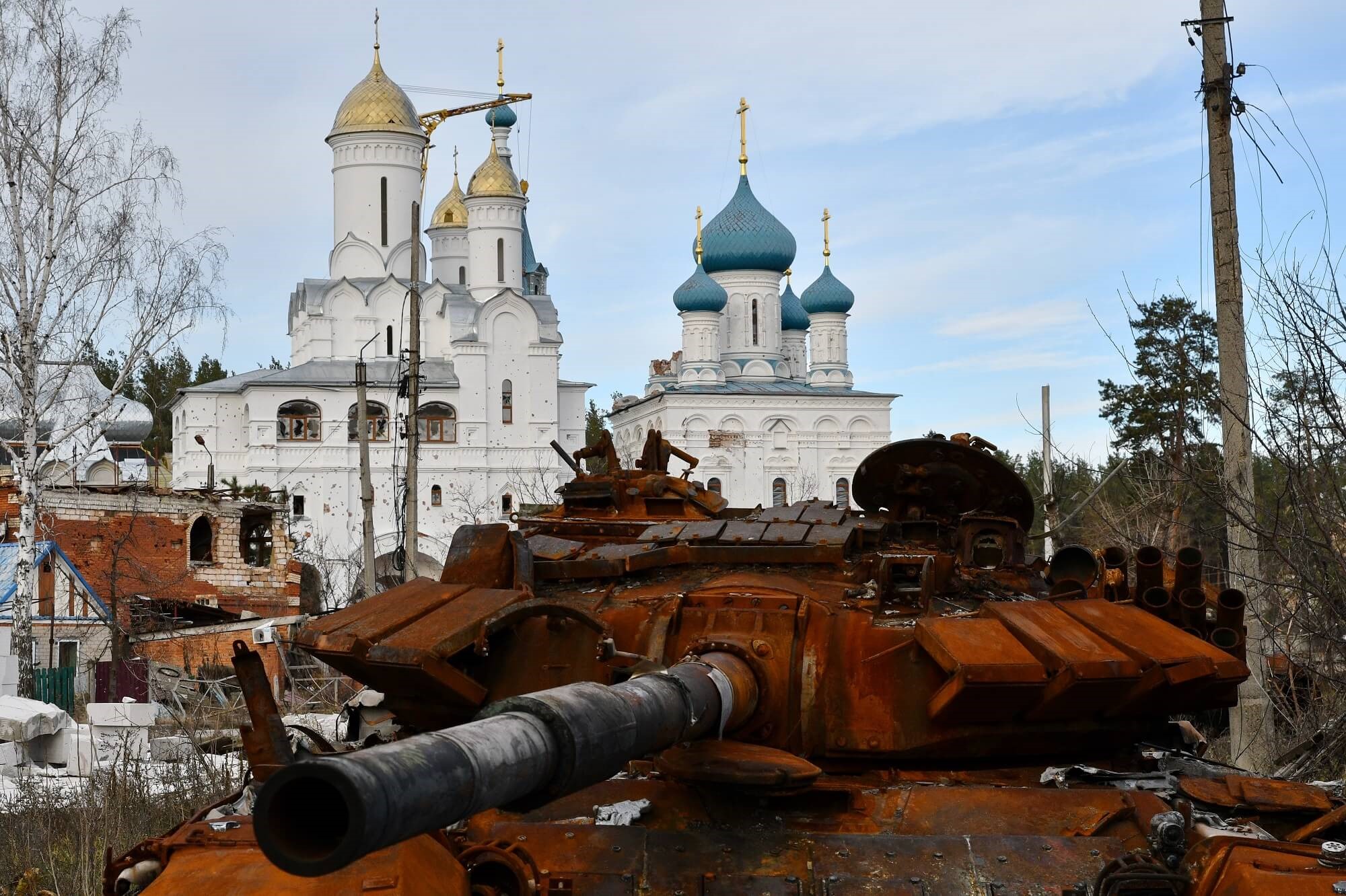 Joachim - A destroyed Russian tank stands by the road in front of an orthodox temple in the liberated town of Sviatohirsk in November 2022. Reuters