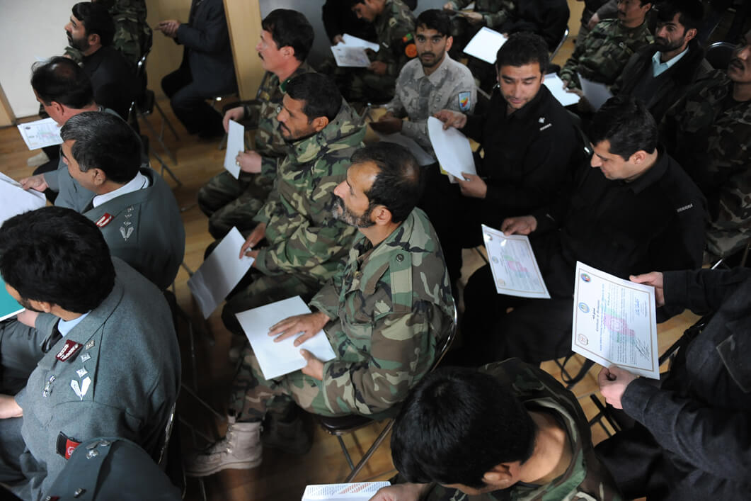 A group of Afghan National Security Force members receive their graduation certificates. ©NATO Training Mission Afghanistan/Flickr