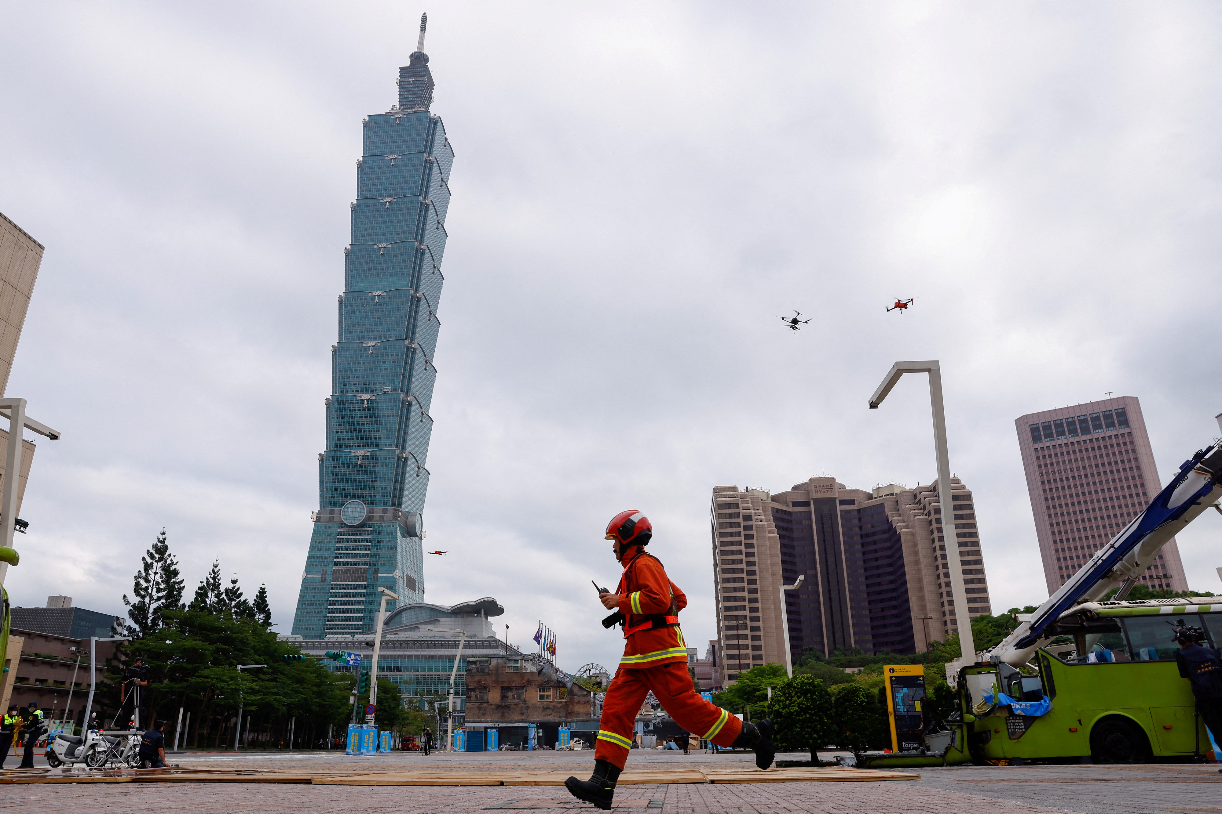 Martin-A firefighter runs during the annual Minan civilian defense drill, which this year focuses on the response from various agencies and volunteer groups if under attack by China in front of Taipei City hall in Taipei, Taiwan May 4, 2023