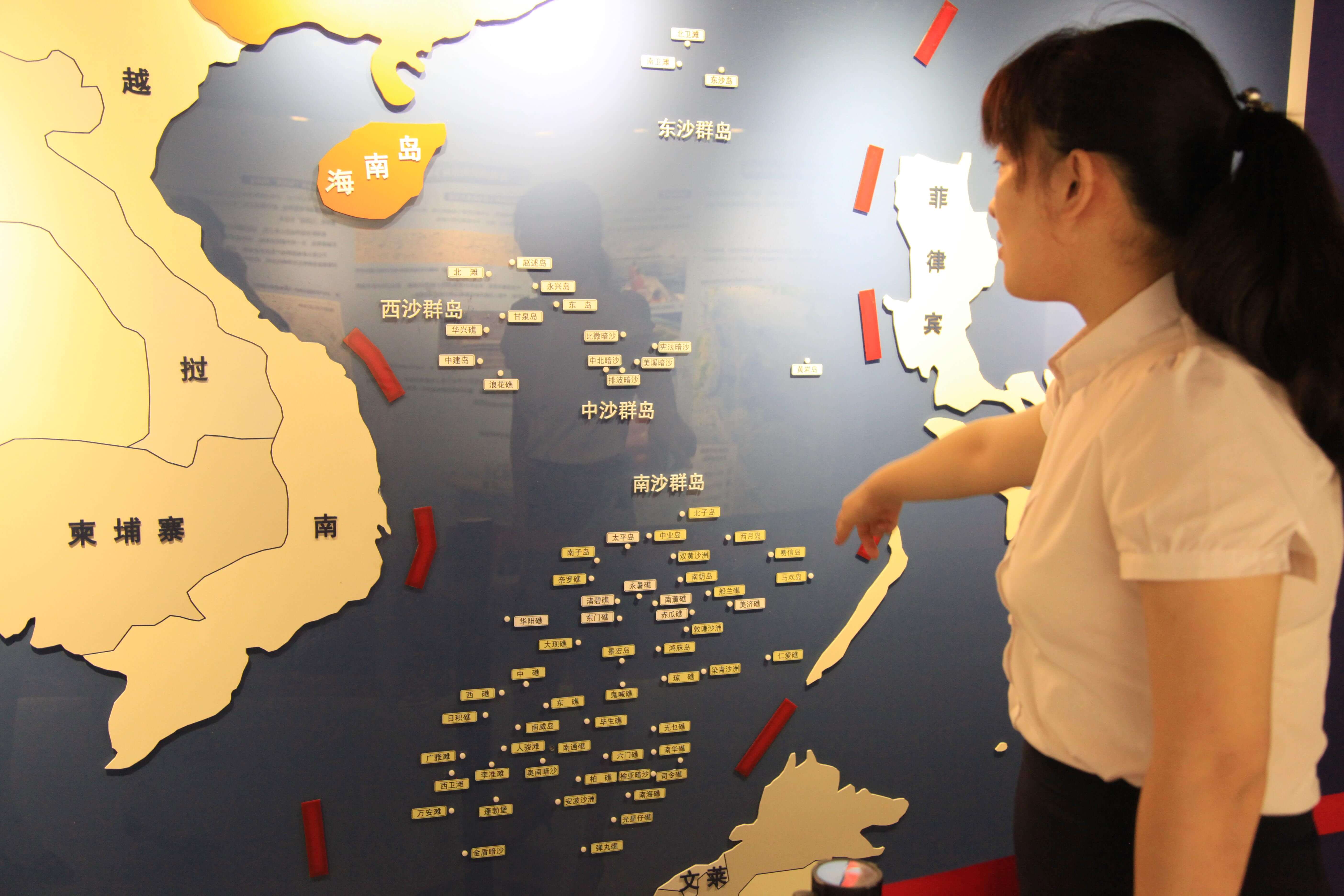 A Chinese visitor looks at a map of the South China Sea and Nansha Islands at a national defence education center in Nanjing city, east China's Jiangsu province, 12 July 2016